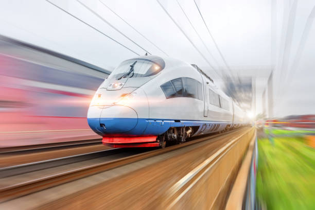istock Electric train with glowing lights traveling at high speed. 1284251494