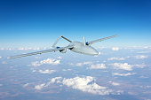 Unmanned military drone uav flying reconnaissance in the air high in the sky in the border areas.