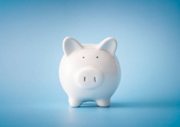istock Piggy bank over blue background 1284252409