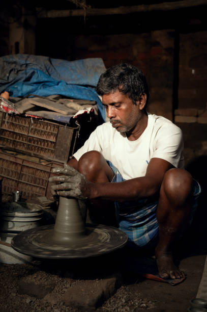 istock A potter prepares clay pot or Diwali diya on potter's wheel 1284252947