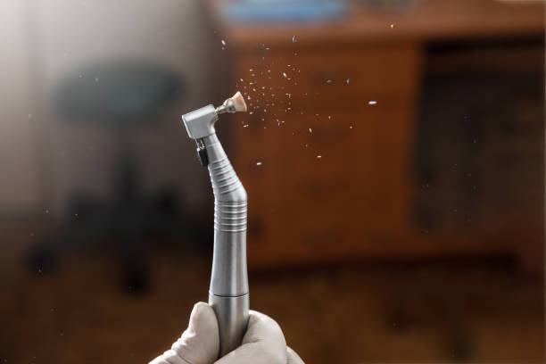 Dental highspeed handpiece and polishing brush in action Dental highspeed handpiece and polishing brush in action with dark background dental drill stock pictures, royalty-free photos & images