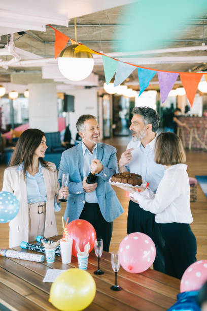 istock Cake and champagne at office party 1284253225