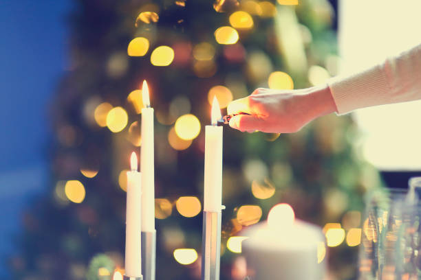 istock Crop woman lighting candles in evening 1284254090