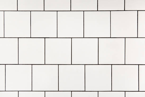 istock White square ceramic tile with black seam, located horizontally. Abstract background, ceramic texture. 1284255715