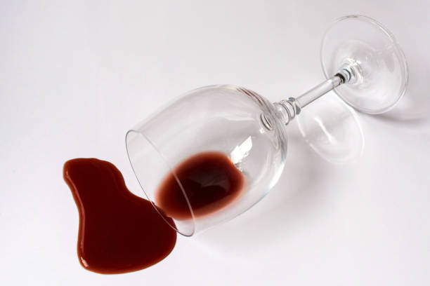 istock Glass with spilled red wine on a white background. Copy space. 1284256856