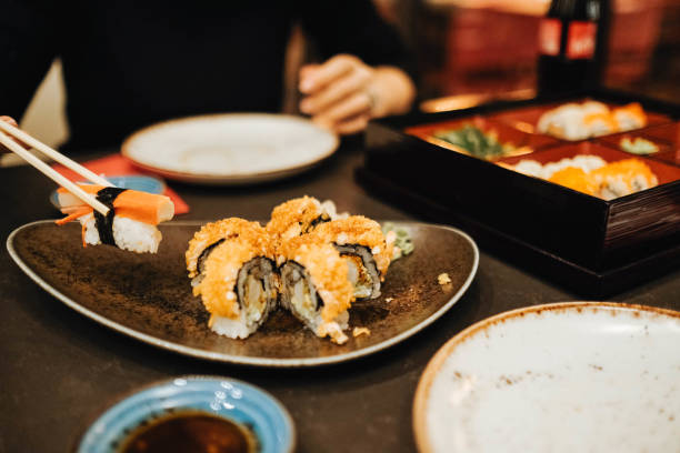 istock Picking up a sushi piece with chopsticks 1284257155