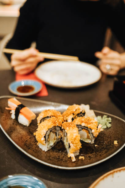 istock Picking up a sushi piece with chopsticks 1284257188
