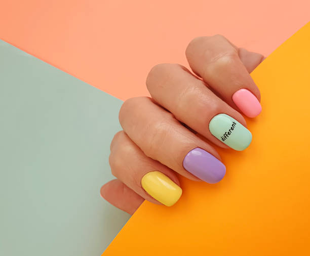 istock female hand beautiful manicure on a colored background 1284259751
