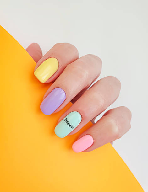 istock female hand beautiful manicure on a colored background 1284260685