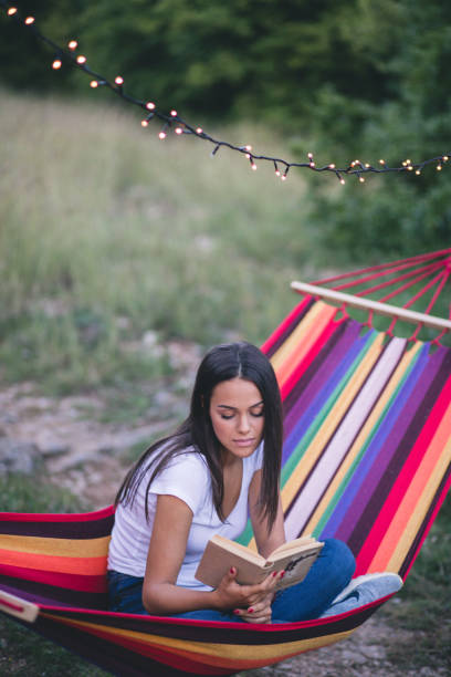 istock Beautiful young girl lying and reading a book 1284260863
