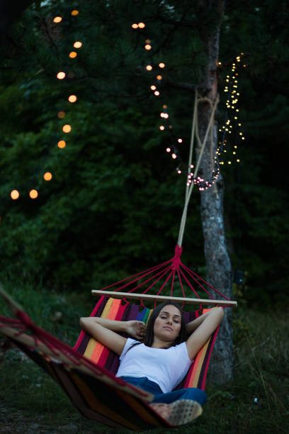 istock Girl resting in a hammock in the park. 1284261539