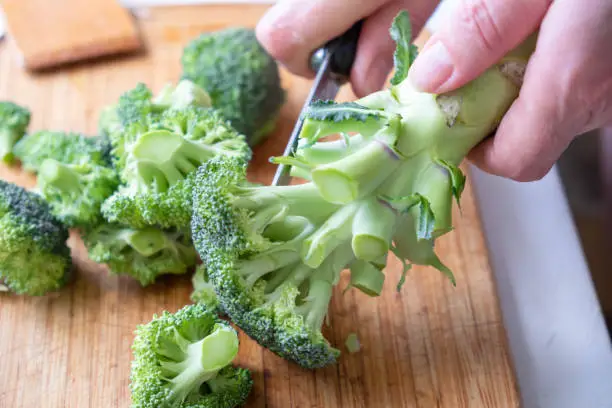 Fresh green broccoli on a wooden cutting board. Macro photo green fresh vegetable broccoli.