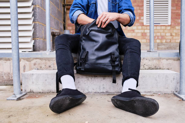 istock Unrecognizable Portrait Of Young Man Sitting With Backpack. 1284264969