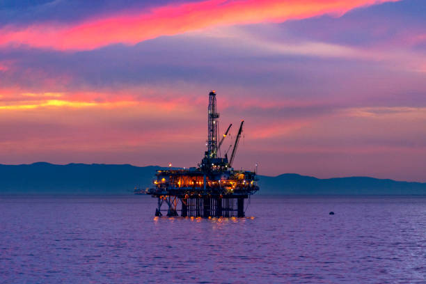 istock Sunset Over Offshore Petroleum Platform in Sea 1284265113