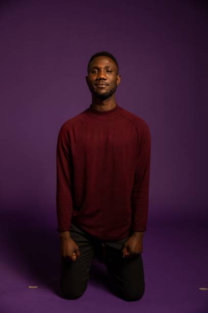 istock Young Black Man Standing on Knees Looking at Camera 1284265264