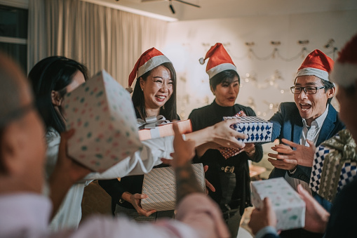 asian chinese office colleague celebrating christmas party after working hour in office lounge