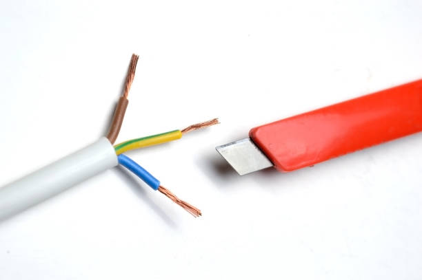 istock stripped three-wire, electric cable and stationery knife. 1284267815