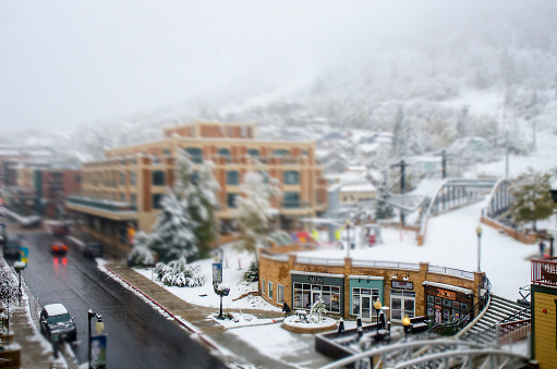 Park City, Utah USA - October 10, 2018 : Early Autumn snow storm in a street shot of Park City Utah. Park City was a small mining town in 1800's . Now it is one of the best ski resort town in Utah. Also known for the Sundance Film Festival in every January. Bus trollies go up and down Main Street and provides free public transportation to everyone.