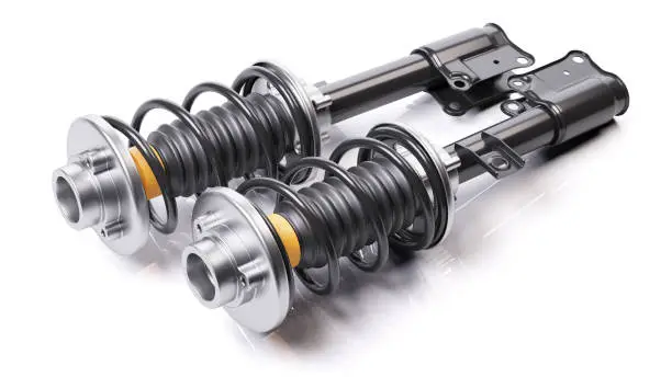 Photo of Pair of car shock absorbers with springs. Suspension components.