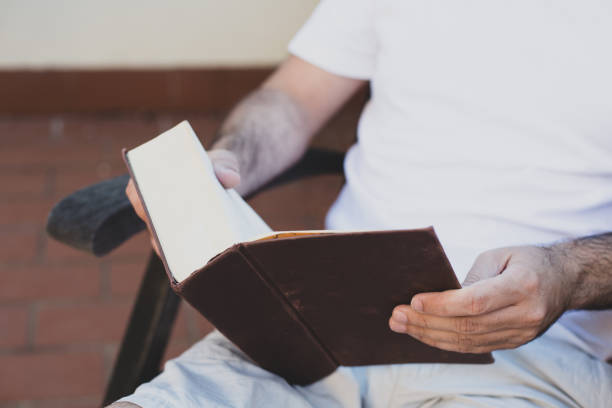 istock Leisure theme. A man is reading a book on the terrace. 1284269097