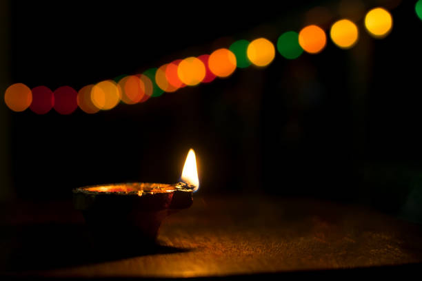 istock Diya with selective focus and black background with the bokeh during Diwali in India. 1284269367
