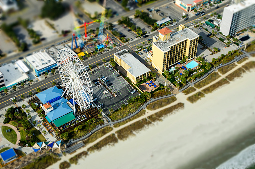 Myrtle Beach,South Carolina, USA - November 4, 2014: Aerial View of the oceanfront Skywheel, Boardwalk, restaurants, condominiums, resorts and hotels along the Grand Strand of Myrtle Beach, South Carolina. Aerial View of the oceanfront condominiums, resorts, hotels and shops along the Grand Strand of Myrtle Beach, South Carolina. Myrtle Beach is a major center of tourism in the United States that attracts an estimated 14 million visitors each year. After the effects of several hurricanes, the city is reinventing itself with new developments and attractions.
