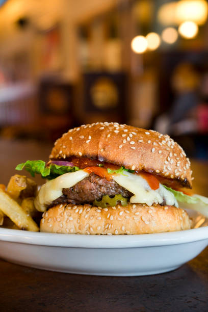 All-American Cheeseburger with fries served at a restaurant