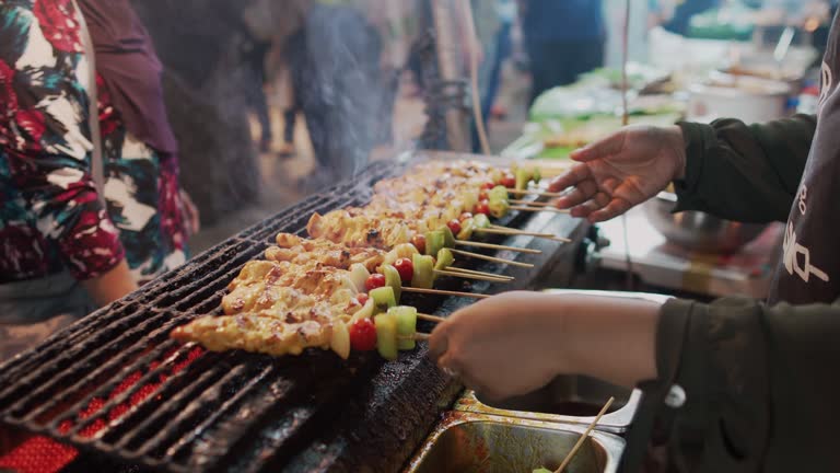 Close up hand of chef cooking at street food night market