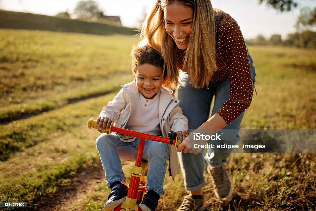 Yes, you can Mother learning her son to drive i bike Family Stock Photo