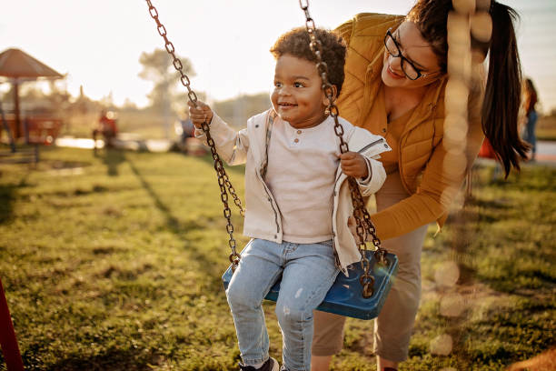 너는 내 세상이다 - child swinging playground african descent 뉴스 사진 이미지