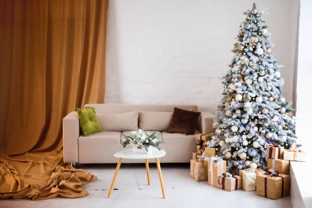 istock Interior of bright modern living room with comfortable sofa decorated with Christmas tree and gifts 1284279908