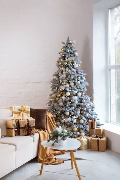 istock Interior of bright modern living room with comfortable sofa decorated with Christmas tree and gifts 1284279940