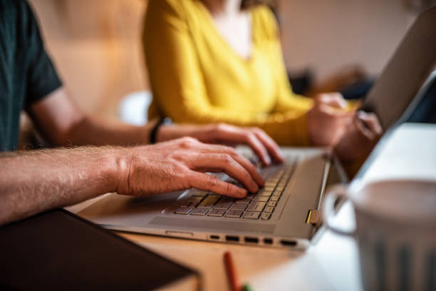 istock Unrecognizable young couple working together at home. 1284279997