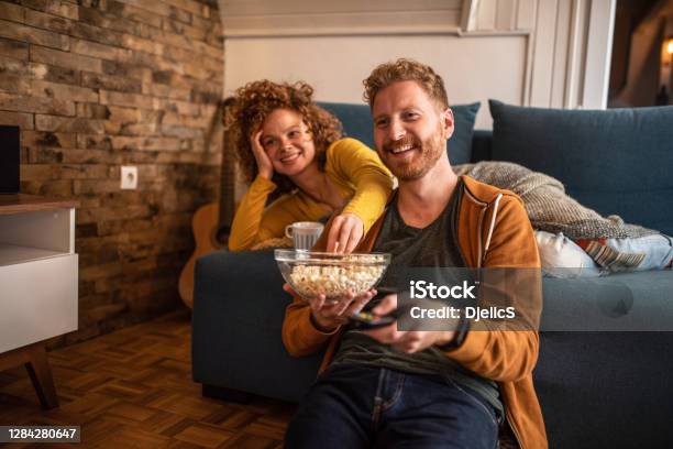 Young Couple Watching A Movie At Home Stock Photo - Download Image Now - Movie, Watching TV, Watching