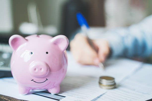 istock Piggy Bank with calculator and documents 1284280657