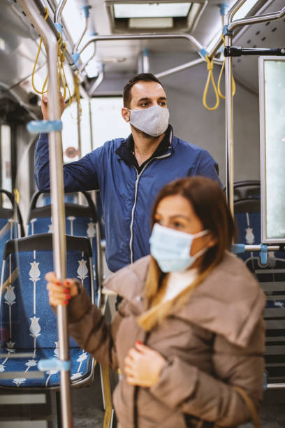 istock People with protective face masks in the bus 1284281093