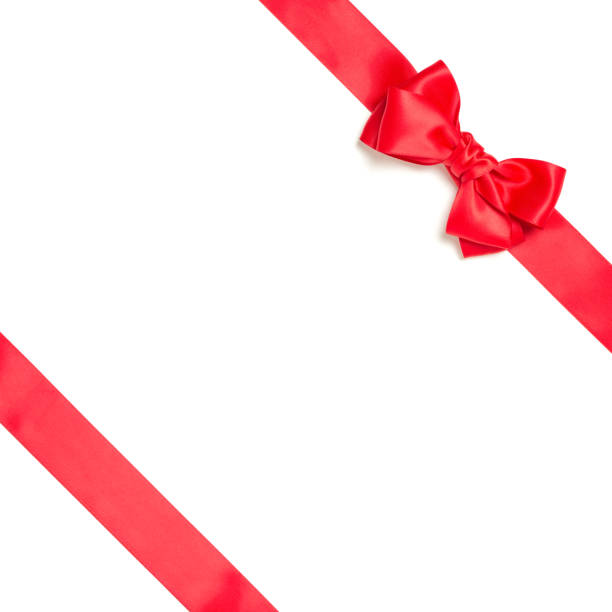 istock Red gift bow and crossed diagonally red ribbon isolated on white background. 1284281136