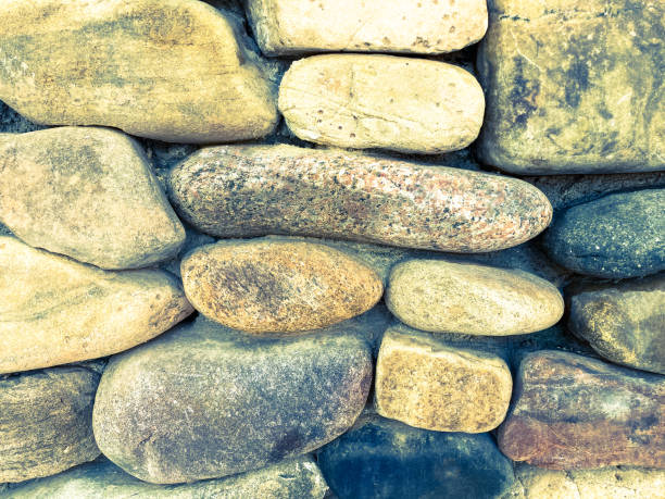 istock River Rock Wall with Yellow-Gray Stone 1284281203