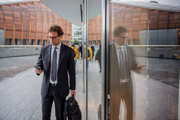 istock Businessman walks through city 1284284124