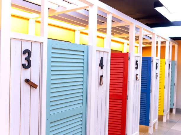 istock Wooden multi-colored fitting booths for trying on clothes from the store. Clean, comfortable and empty fitting rooms 1284284335