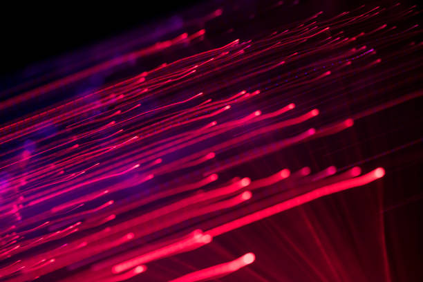 Abstract background with defocused lines and spots in red / purple tones. Fiber optics.