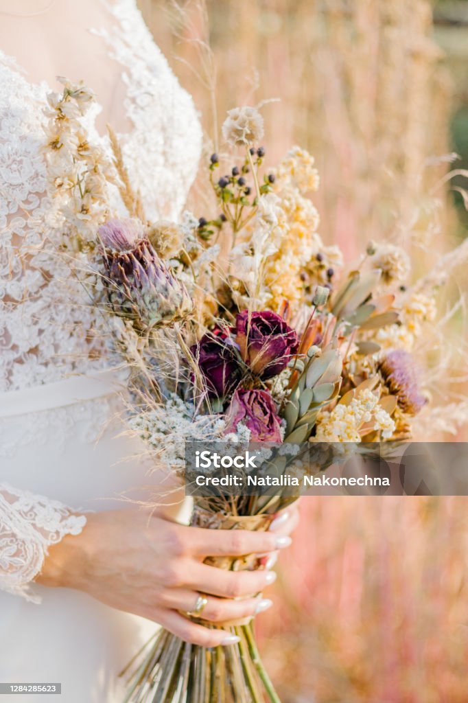 A Bouquet Of Dried Wildflowers In The Hands Of The Bride Close Up Stock  Photo - Download Image Now - iStock