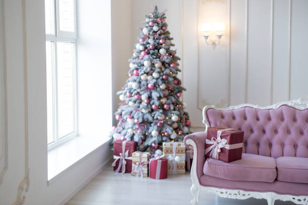 istock Interior of bright modern living room with comfortable sofa decorated with Christmas tree and gifts 1284286871