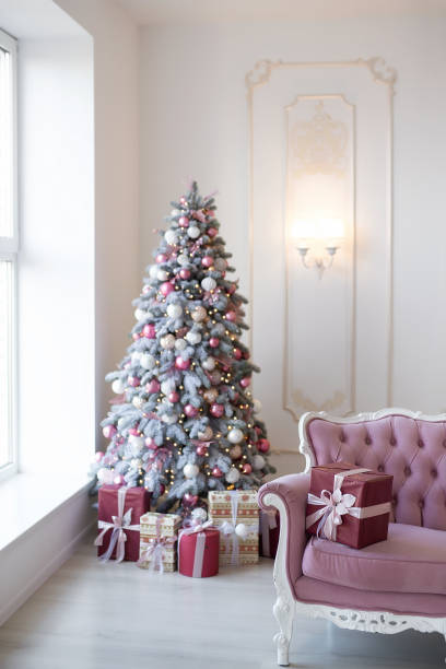 istock Interior of bright modern living room with comfortable sofa decorated with Christmas tree and gifts 1284286879