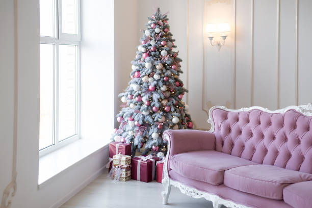 istock Interior of bright modern living room with comfortable sofa decorated with Christmas tree and gifts 1284286893