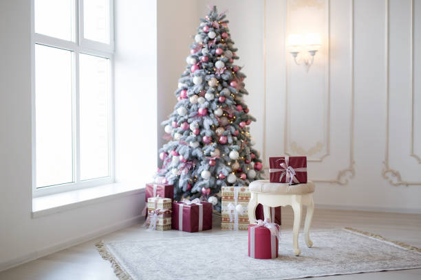 istock Interior of bright modern living room with comfortable sofa decorated with Christmas tree and gifts 1284286905