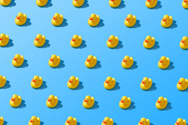 istock Flat lay of a creative summer yellow rubber duck pattern 1284287712
