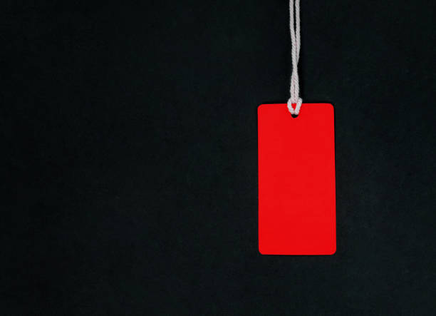 istock Red fashion label tag mockup at black background. 1284289712