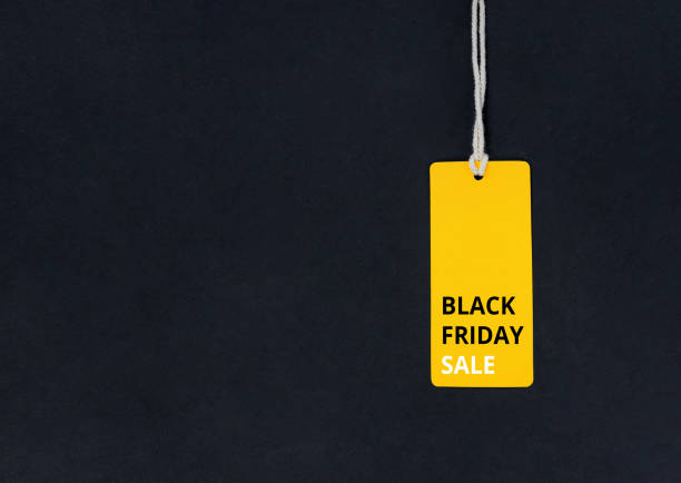 Black friday. Yellow Sale tag on the black background