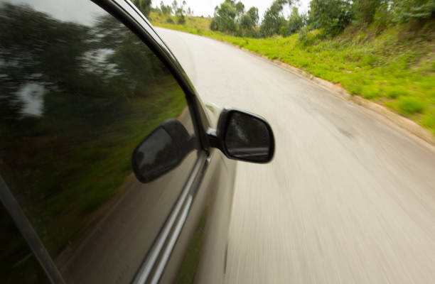 istock Speed black car in a curve on the road 1284289774